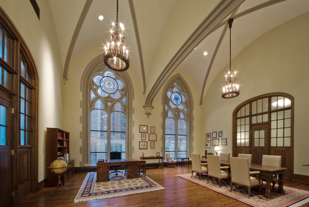 Interior view of Cardinal's office with arched stained glass windows and vaulted ceilings.